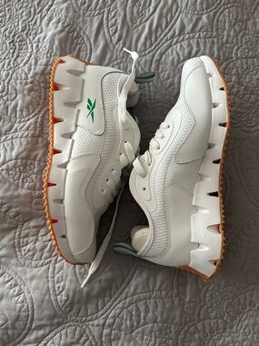 Reebok White Lace-Up Sneakers with Orange Outsole and Green Logo